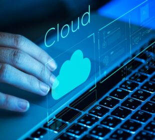 Hand interacting with a laptop displaying a digital cloud icon, symbolizing cloud storage services and technology.