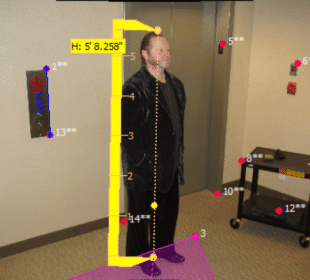 Image depicting a person standing next to an elevator, with measurement markers indicating height and body dimensions for crime scene video analysis.